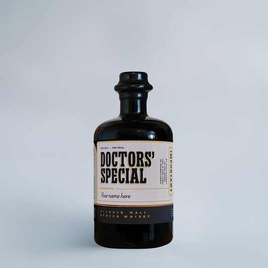 A dark glass bottle of 'Doctors' Special' aged blended malt whisky, featuring a cream and black label, set against a clean light gray background.