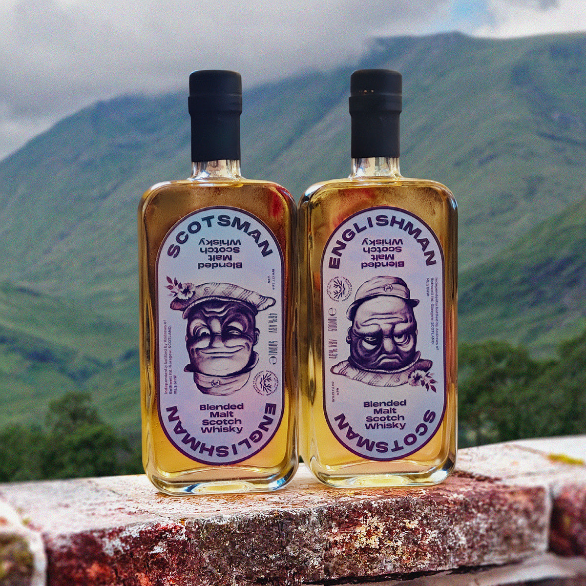 Scotsman and Englishman bottles on a brick wall with green Highland hills behind