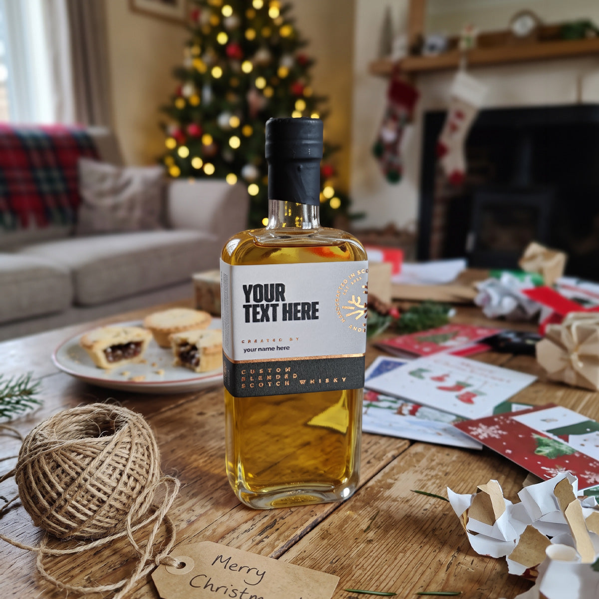 Personalised 200ml whisky on a festive table with mince pies and Christmas wrapping